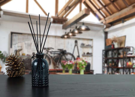 luxury aroma scent reed diffuser à¸´black glass bottle are on black wooden table to creat...