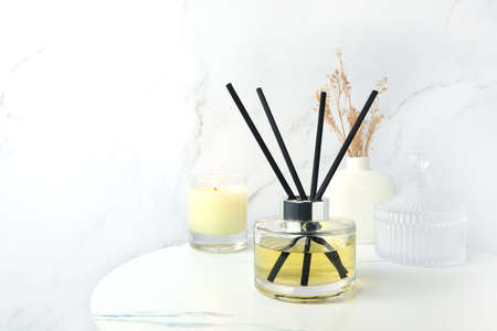 luxury aromatic scent of reed diffuser glass bottle is used as room freshener on the marble table...