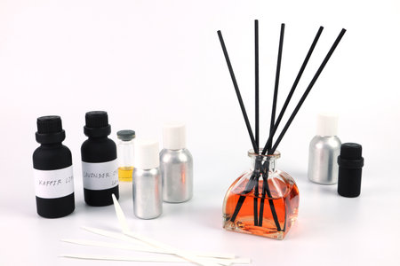 aroma reed diffuser bottle is on  white table with essential oil bottles , fragrance oil bottles and blottle testing papers during testing process to blend  new scent for aroma reeの写真素材