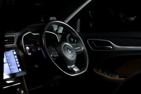 car steering wheel of MG ZS model and led speedmeter speed gauge with navigator idrive display inside cabin in black and brown leather stitch color tone with kevlar decoratedのeditorial素材