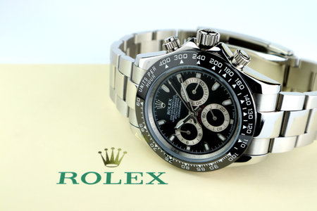 Rolex vintage wristwatch ceramic bezel model Cosmograph Daytona display on background of ivory package with Rolex crown logo on white table in luxury watch shopのeditorial素材