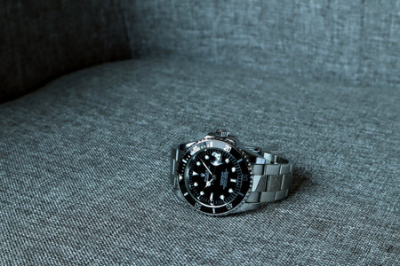 The Rolex vintage wristwatch ceramic bezel model black oyster perpetual submariner date 39 mm display on nice brown sofaのeditorial素材