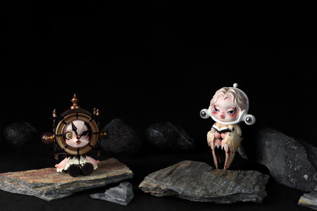 cute art toys skullpanda image of reality collection from Pop Mart blind box collectable cute toys display on black shelf with some rocks with black background in Popmart flagshipのeditorial素材