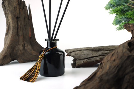 luxury aroma scent reed diffuser glass bottle is on wooden table and vintage wood wall background in...