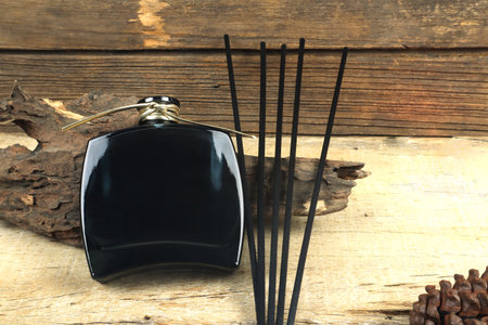 luxury aroma scent reed diffuser glass bottle is on wooden table and vintage wood wall background in...