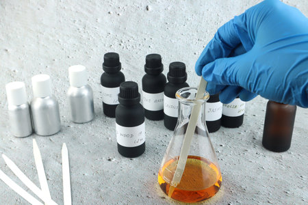 chemical beaker , flask is used on stone table with blotting paper , fragrance bottle and essential...