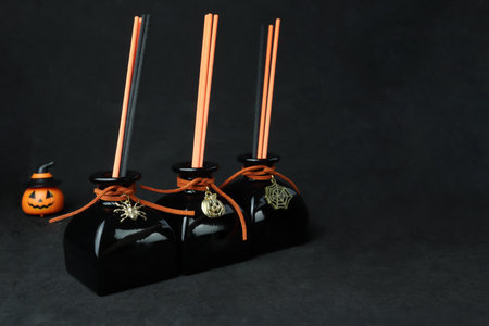 black aroma scent reed diffuser glass bottle on black table to create mystery and luxury ambient...