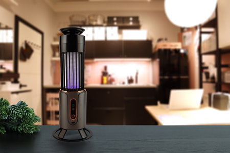 insects mosquito electric blue light killer lamp is put on nice wooden table in nice livingroom with background of table cupboard laptop and nice lampの写真素材