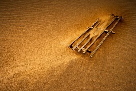 lost fence in the middle of a sand duneの写真素材