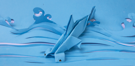 Fold a piece of paper, Fold the shark into the sea.の写真素材