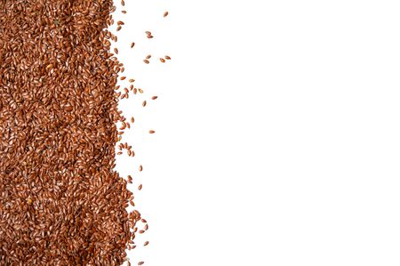heap of brown flax seeds isolated on white backgroundの写真素材