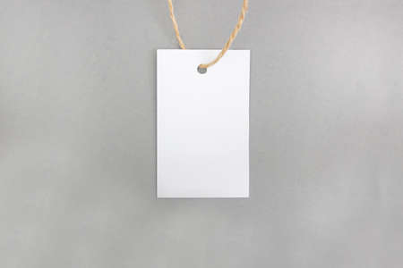 White price tag on a gray background. mockup. Place for text. Concept of healthy consumerism.の写真素材