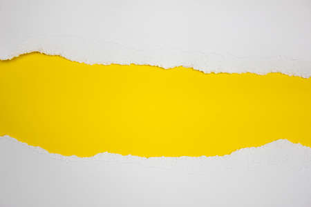 Torn white stripes on a yellow background. Copy space.の写真素材
