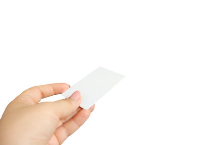 Female hand holding business card isolated on white backgroundの写真素材