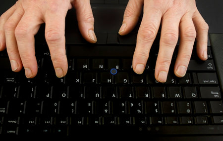 female old hands on keyboard close up. View from above.の写真素材