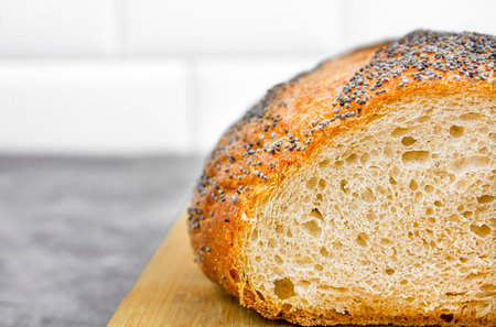 Freshly baked wheat bread on a wooden board. Copy space.