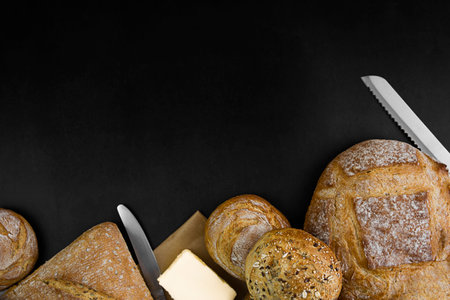 Freshly baked bread on a black background. copyspace. bakery concept.の写真素材