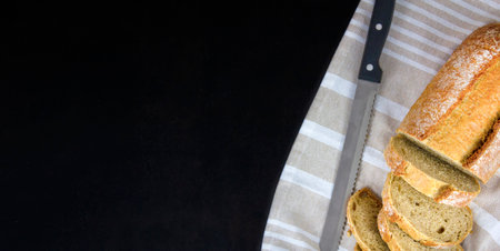 Freshly baked bread on black table, top view. copyspace.の写真素材