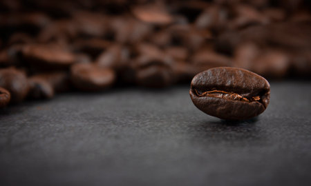 Roasted coffee beans on a dark background, close up. soft focus.