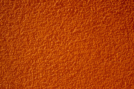 Abstract orange background. Plastered textured wall. Bright wallpapers.の写真素材
