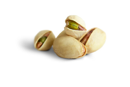 Several ripe pistachios isolated on a white background.の写真素材