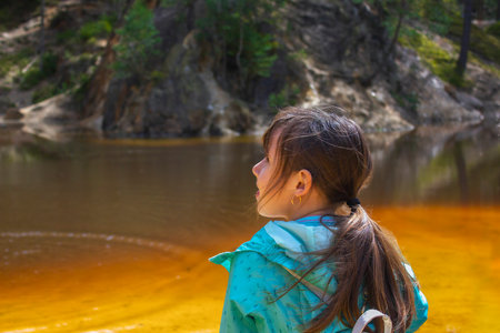 little girl on the background of a mountain lake. Kolorowe jeziorka in Poland.