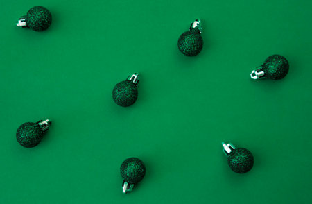 Green Christmas balls on a green background.の写真素材