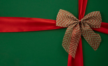 Bow and red ribbon on a green background.の写真素材