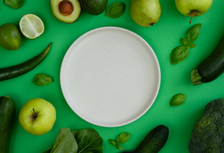 Fresh veggies and fruits around an empty plate.の写真素材