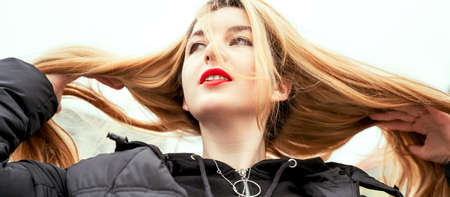 Beautiful sexy girl with red bright lips and long smooth blond hair. Young attractive sensual woman. Bannerの写真素材