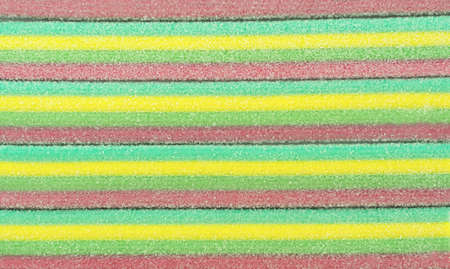 Marmalade stripes. Colorful rainbow background. Sugar gummy surface close upの写真素材