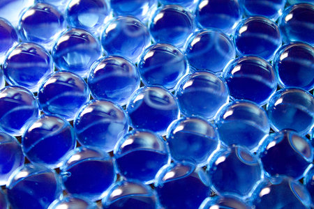 Water blue gel balls. Polymer gel. Silica gel. Balls of blue hydrogel. Crystal liquid ball with reflection. Texture background. Close up macroの写真素材