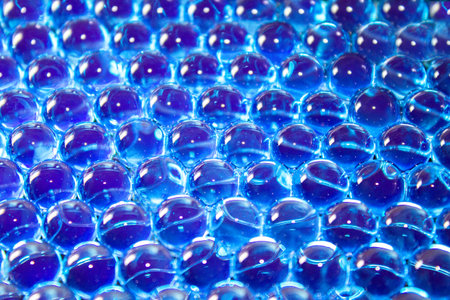 Water blue gel balls. Polymer gel. Silica gel. Balls of blue hydrogel. Crystal liquid ball with reflection. Texture background. Close up macroの写真素材