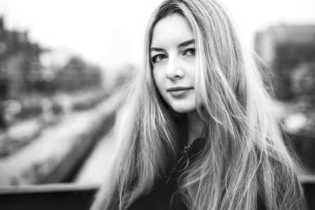 Portrait of sensual beautiful girl with long hair. Young cute woman outdoors. Natural beauty and youth. Black and white photoの写真素材