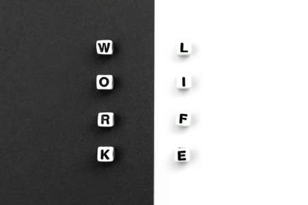 Work and life. Cubes on black white background. Concept of balance, harmony, no stress. Choiceの写真素材