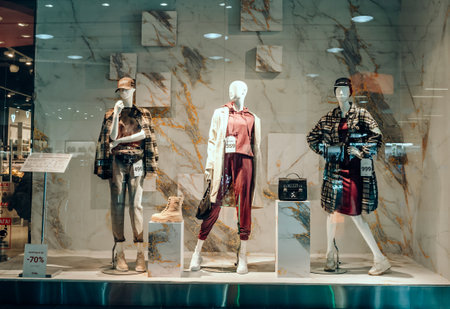 UKRAINE, KHERSON - October 1, 2021: Three female mannequins in a shop window. Fashionのeditorial素材
