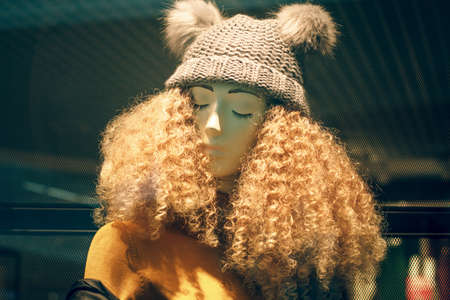 POLAND, BYDGOSZCZ - 15 February 2020: Funny mannequin in shop window. Female dummy with unruly curly hair and hat. Women's shopping. Beauty industryのeditorial素材