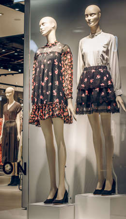 POLAND, BYDGOSZCZ - March 1, 2020: Female mannequins show spring clothes collection. Standing dummies in store window. Dress, trousers and white blouse. Female shopping. Advertising Saleのeditorial素材