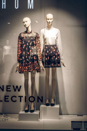POLAND, BYDGOSZCZ - March 1, 2020: Female mannequins show spring clothes collection. Standing dummies in store window. Dress, trousers and white blouse. Female shopping. Advertising Saleのeditorial素材