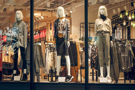 POLAND, TORUN - March 1, 2020: Three female mannequins in store window show spring summer clothing collection. White stylish dummiesのeditorial素材