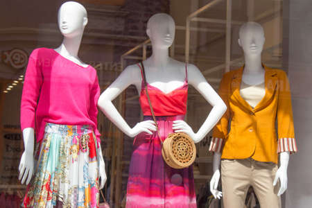 POLAND, TORUN - March 1, 2020: Three female mannequins in store window show spring summer clothing collection. White stylish dummiesのeditorial素材