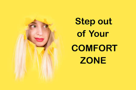 Step out of your Comfort Zone. Funny girl with expression peeks out from yellow poster. hallenge motivation call to actionの写真素材