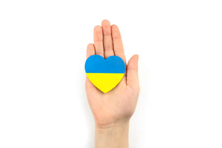 Two hearts with flags of poland and ukraine in hands on gray background. unity solidarity help conceptの写真素材
