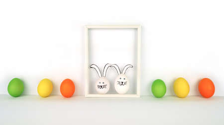 Happy Easter. Creative card from colorful eggs in row and two funny rabbits in frame. white backgroundの写真素材