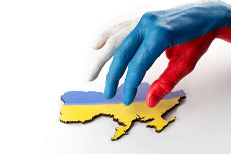 Male hands hold map of Ukraine on black background. Ukrainian blue yellow flag. conceptの写真素材