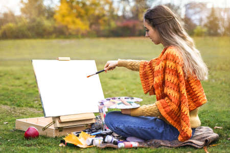 girl with camera outdoors. woman takes pictures. Hobby leisure or professionの写真素材