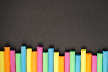 Multicolored chalk on black board. back to school. colored background. Bannerの写真素材