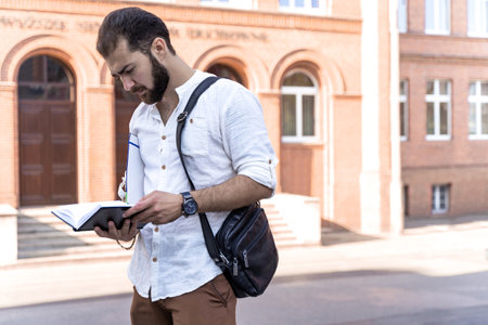 Confident handsome man. Young business man in white shirt talking on phone outdoors. Self employed professional. business negotiationsの写真素材