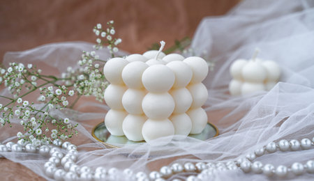 Beautiful adult woman looks at fire of candle. Portrait of a pensive girl. conceptの写真素材
