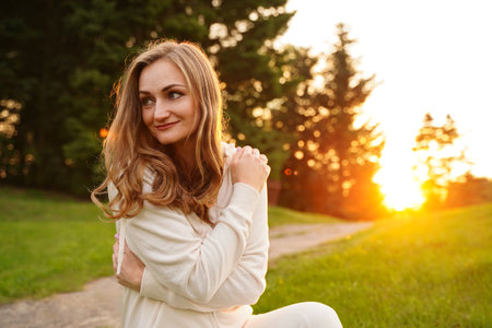 Pretty woman with blue eyes outdoors. Smiling blonde girl on the background of nature. Portrait of an ordinary womanの写真素材
